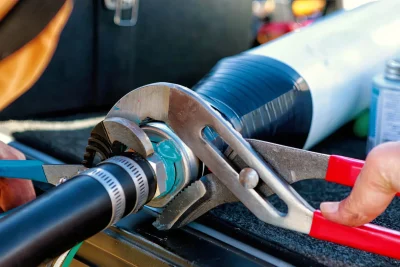 Technician tightening an industrial pipe connection in Fort Pierce