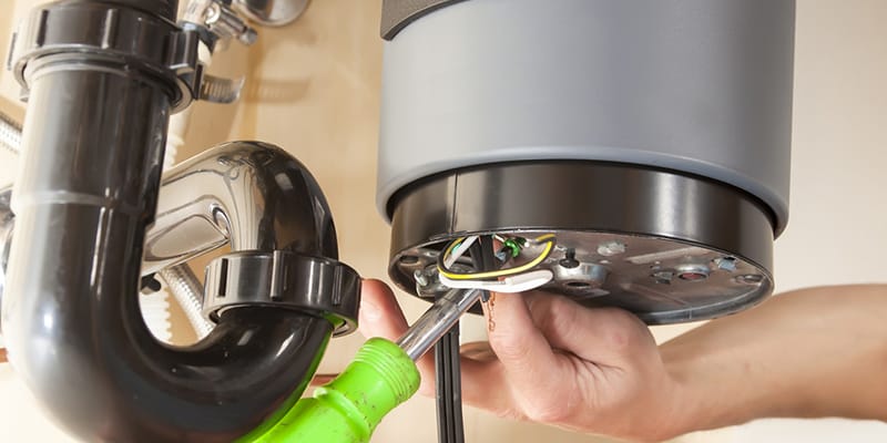 Technician repairing the heating element of a water heater in Fort Pierce