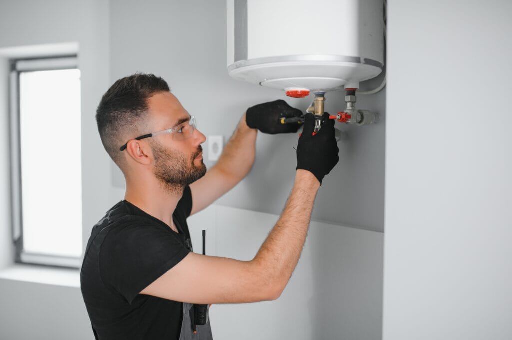 Technician performing water heater maintenance in Fort Pierce