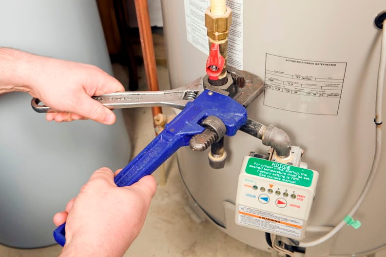 Plumber repairing a water heater valve in Fort Pierce